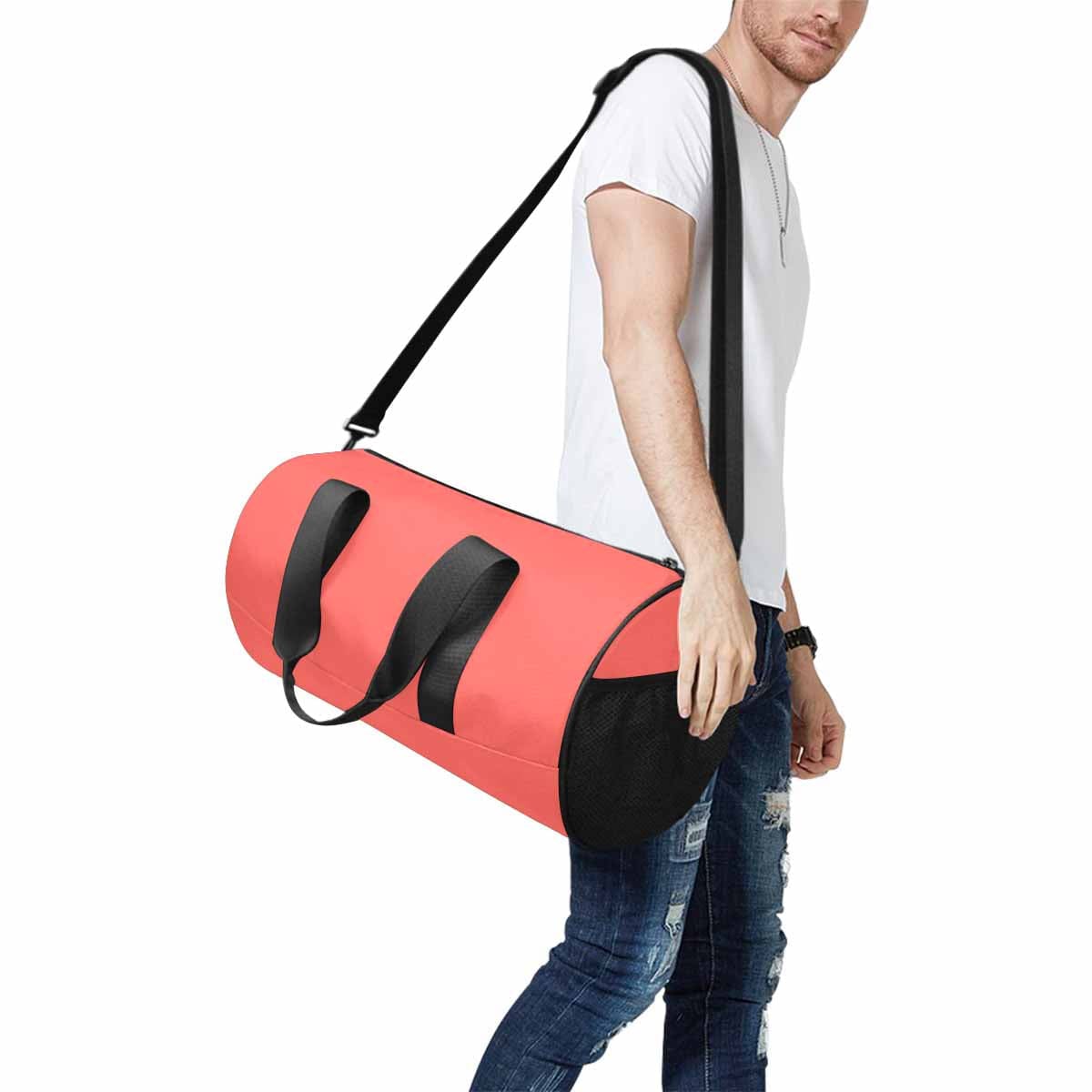 Pastel Red Travel Duffel Bag made from waterproof fabric with spacious compartments and adjustable straps.