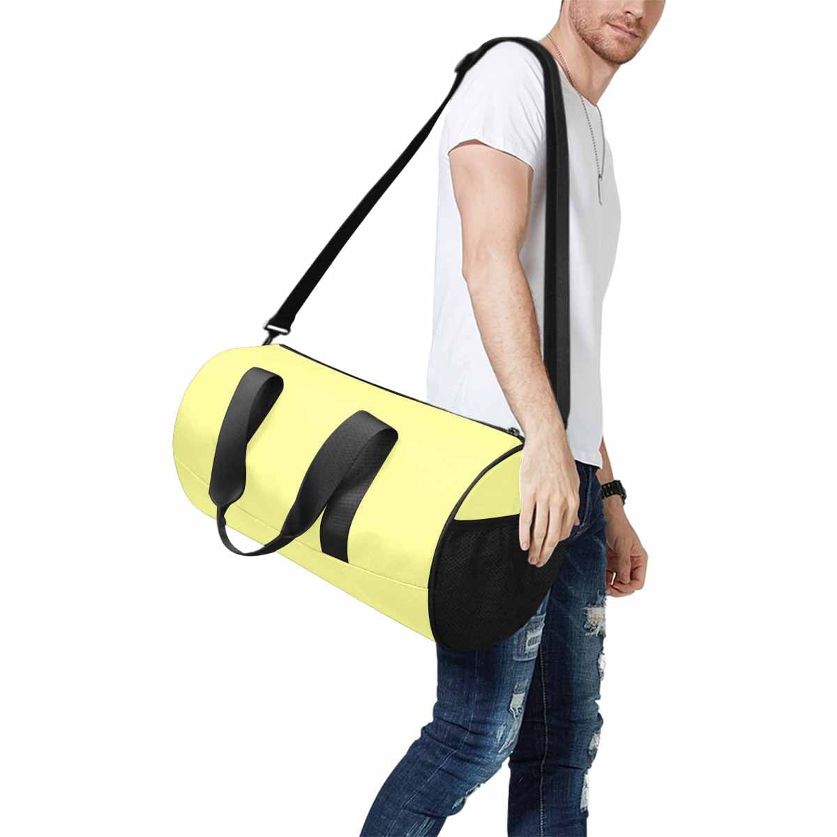 Pastel yellow travel duffel bag with waterproof fabric and adjustable strap, ideal for sports and travel.