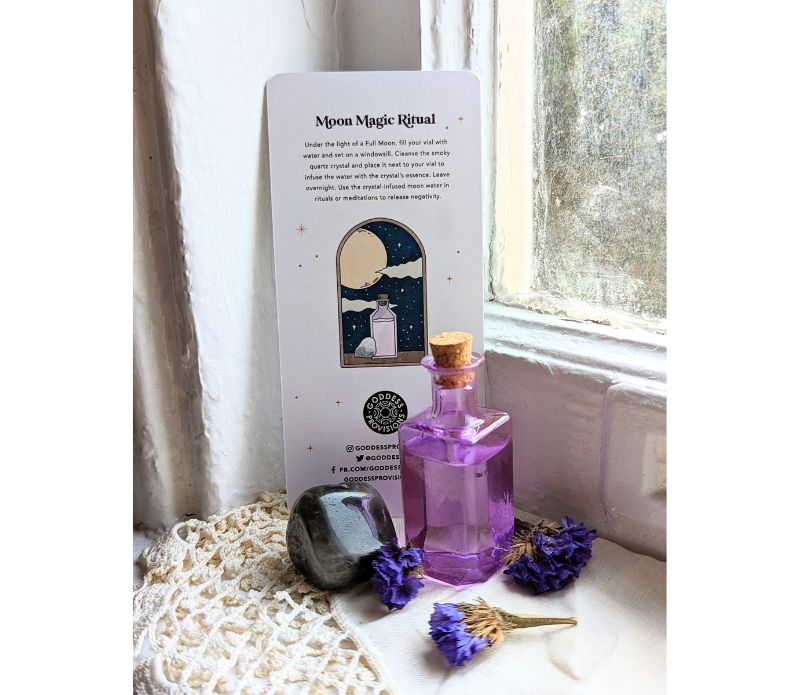 Travel Ritual Kit by Goddess Provisions featuring essential oil, crystal, brass tongs, and glass vial for spiritual practices.