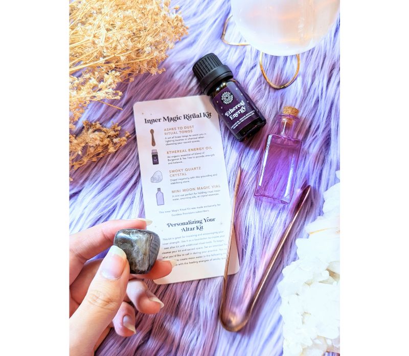 Travel Ritual Kit by Goddess Provisions featuring essential oil, crystal, brass tongs, and glass vial for spiritual practices.