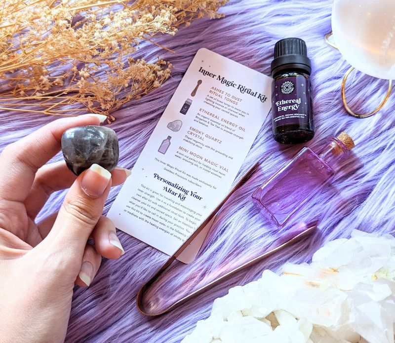 Travel Ritual Kit by Goddess Provisions featuring essential oil, crystal, brass tongs, and glass vial for spiritual practices.