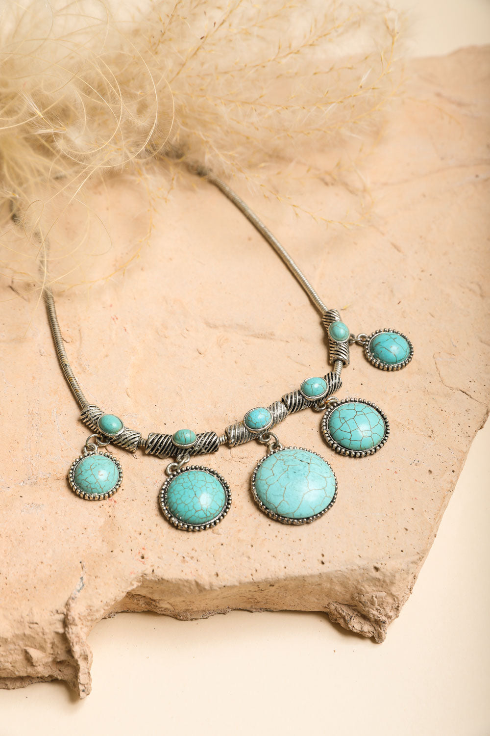 Turquoise Charm Link Necklace featuring five rounded turquoise stones linked on a silver chain, showcasing elegance and style.