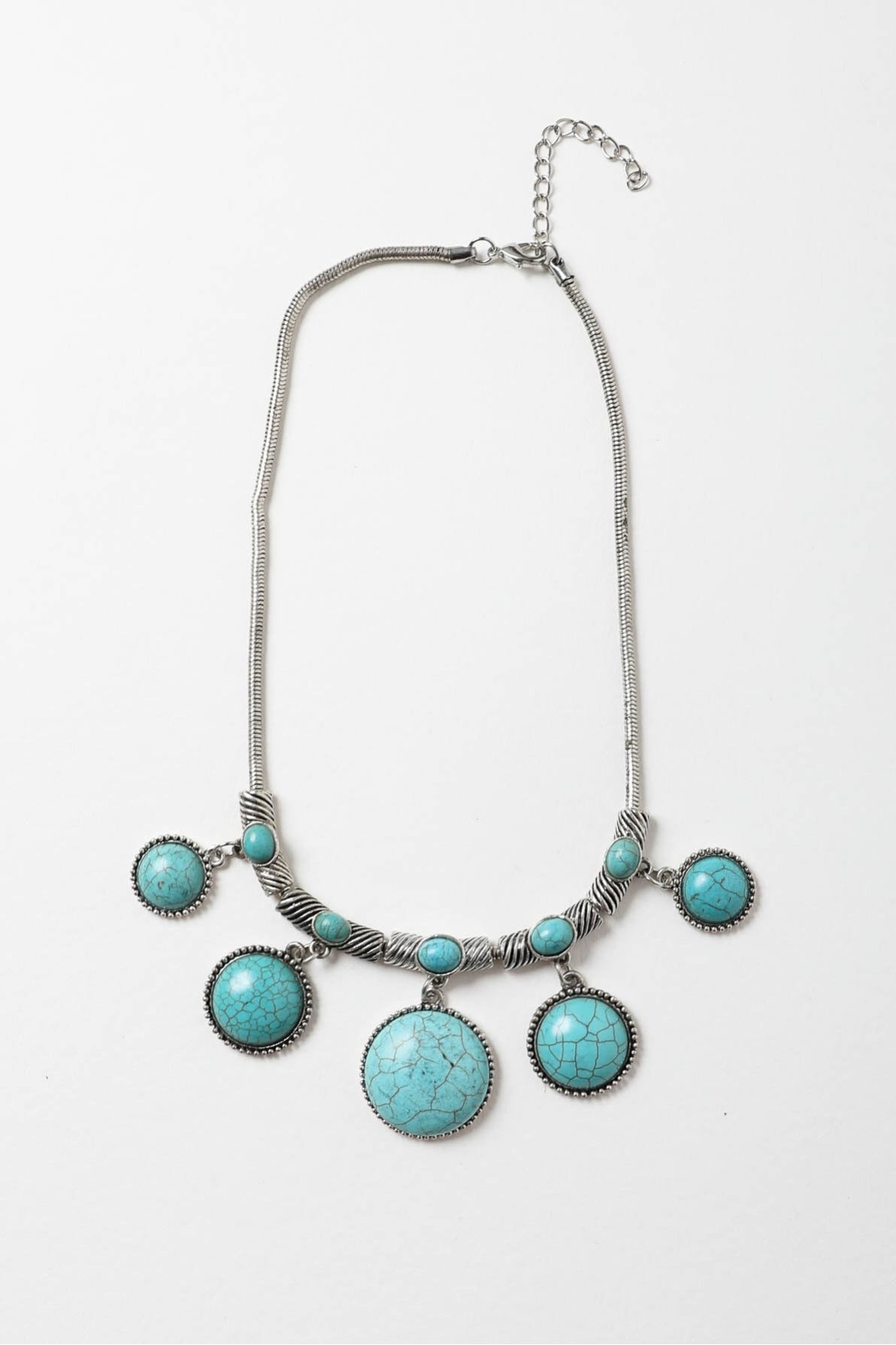 Turquoise Charm Link Necklace featuring five rounded turquoise stones linked on a silver chain, showcasing elegance and style.