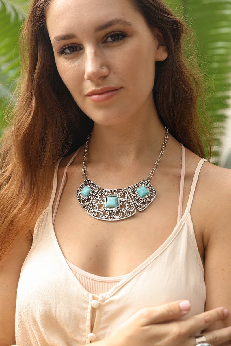 A beautiful Turquoise Deco Necklace featuring hand-cut turquoise stones set in a durable silver collar design, showcasing vibrant colors.