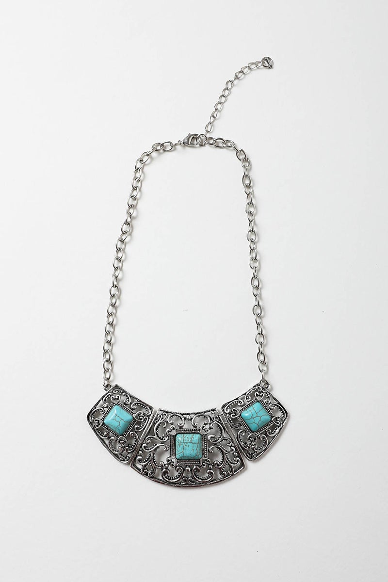 A beautiful Turquoise Deco Necklace featuring hand-cut turquoise stones set in a durable silver collar design, showcasing vibrant colors.