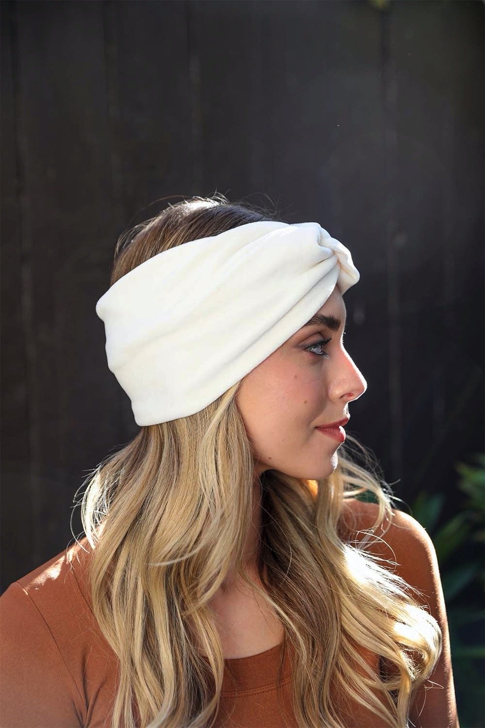 A collection of Twisted Velvet Headbands in various colors, showcasing their soft texture and elegant twisted design.