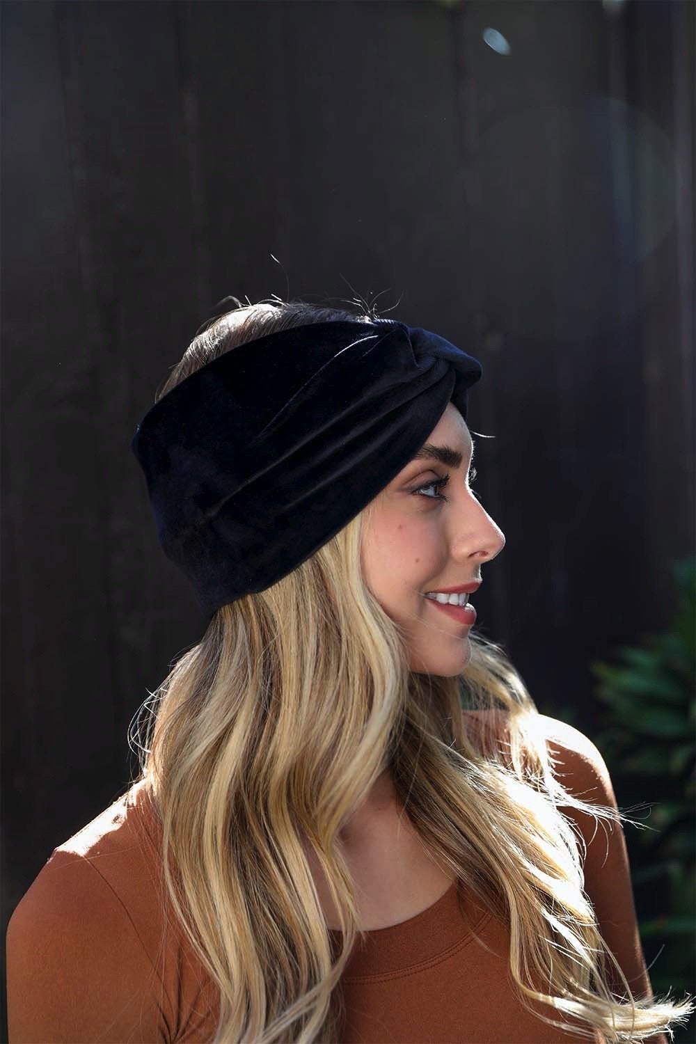 A collection of Twisted Velvet Headbands in various colors, showcasing their soft texture and elegant twisted design.