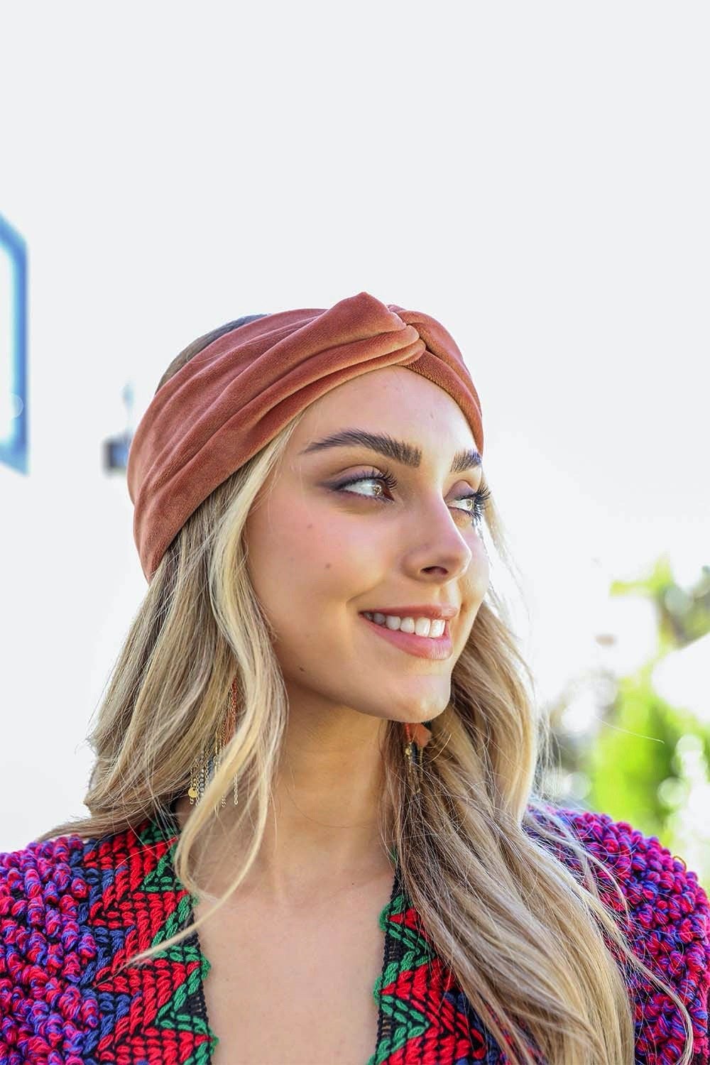 A collection of Twisted Velvet Headbands in various colors, showcasing their soft texture and elegant twisted design.