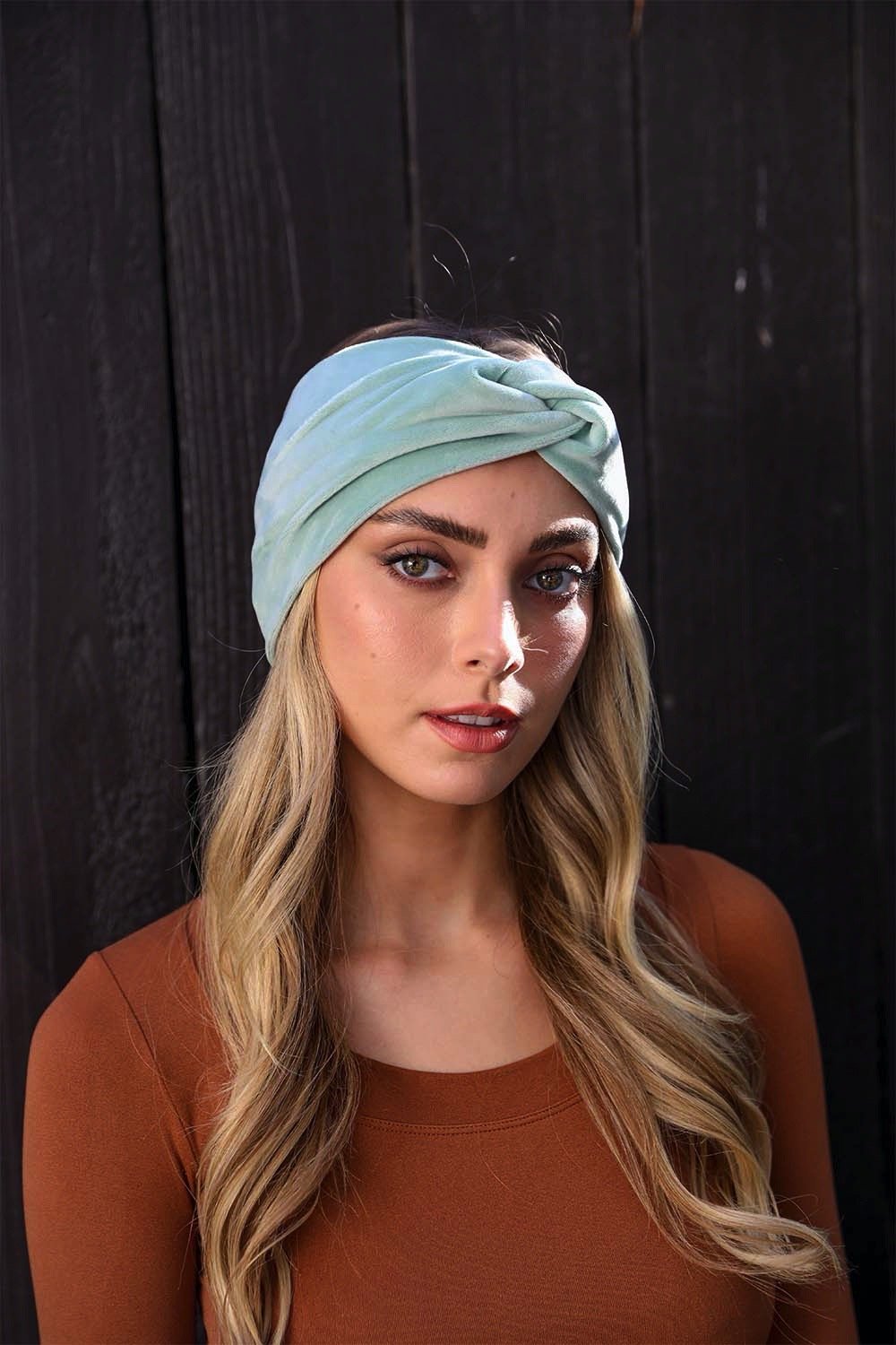 A collection of Twisted Velvet Headbands in various colors, showcasing their soft texture and elegant twisted design.