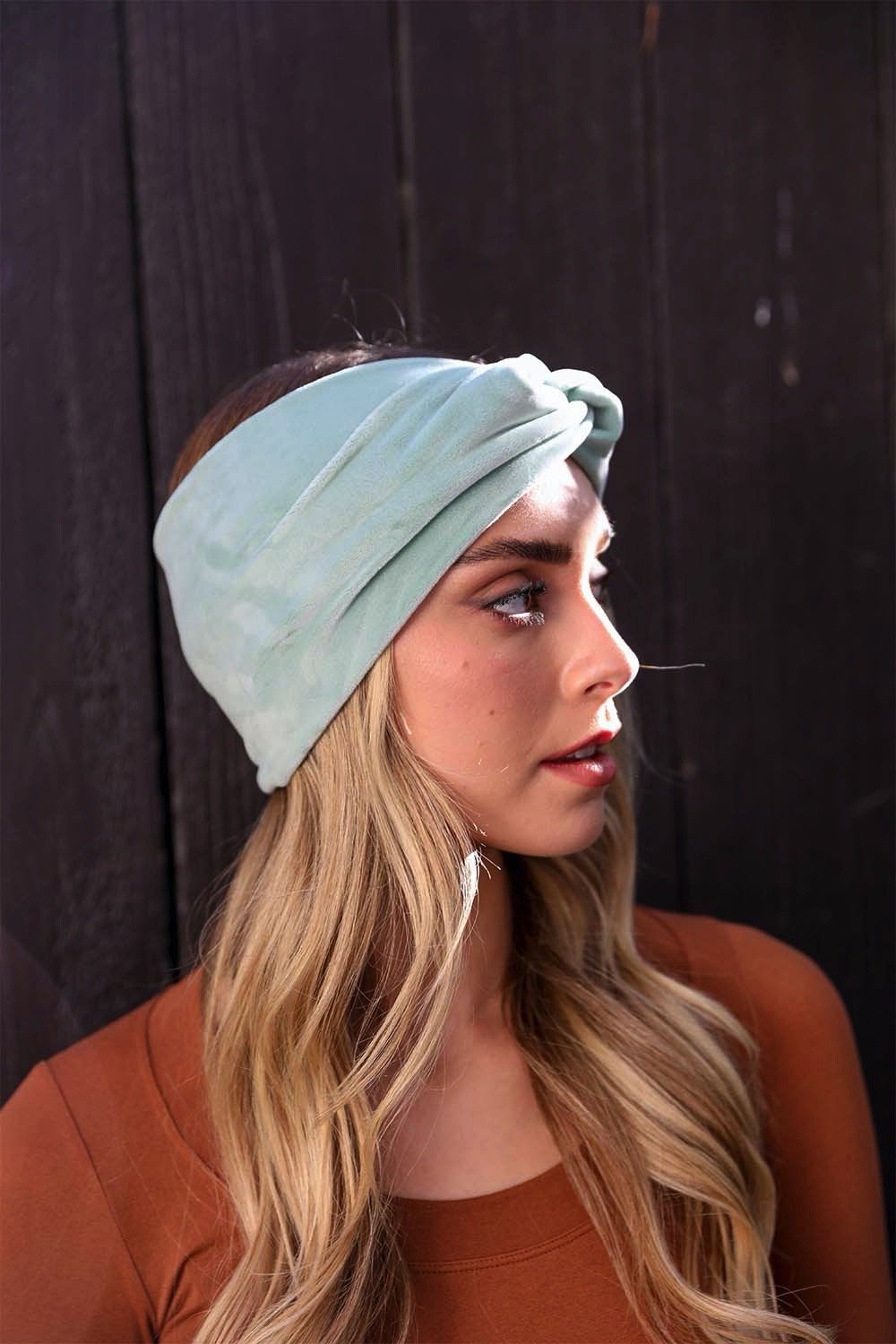 A collection of Twisted Velvet Headbands in various colors, showcasing their soft texture and elegant twisted design.