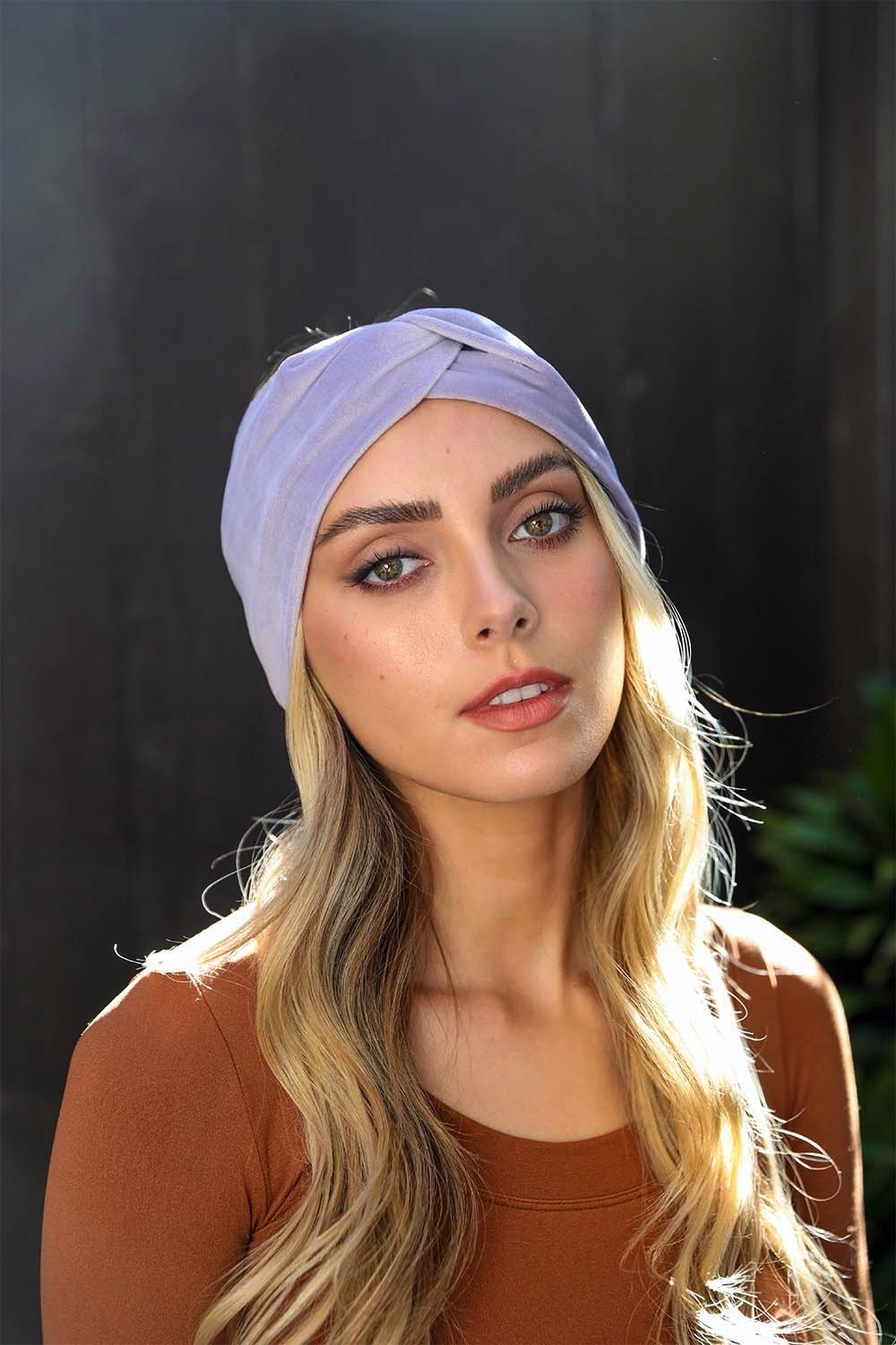 A collection of Twisted Velvet Headbands in various colors, showcasing their soft texture and elegant twisted design.