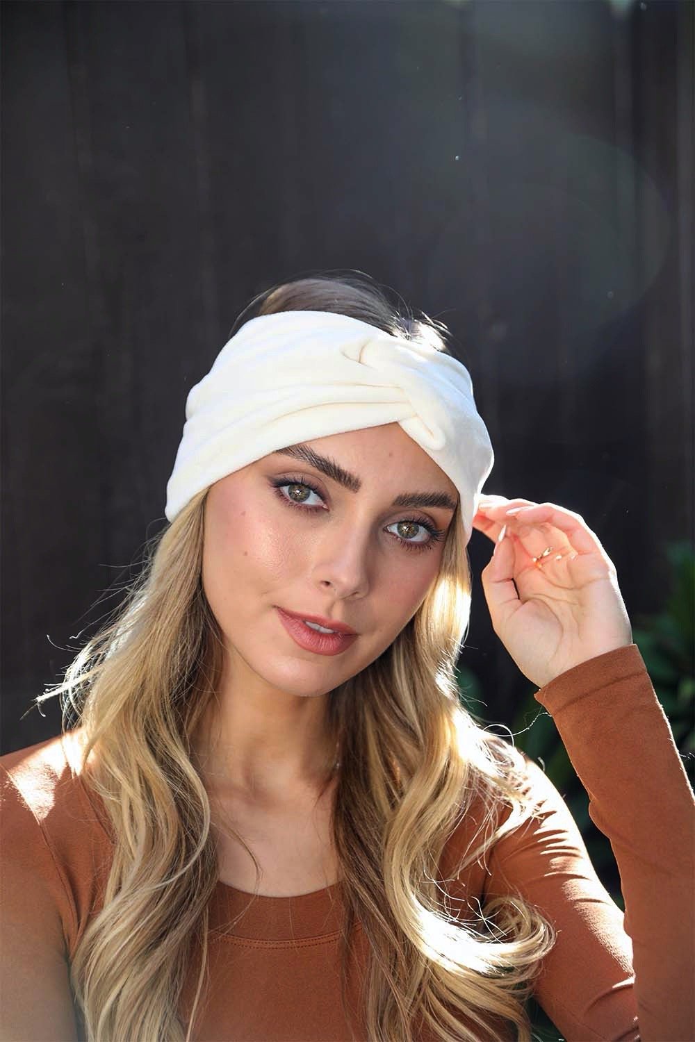 A collection of Twisted Velvet Headbands in various colors, showcasing their soft texture and elegant twisted design.