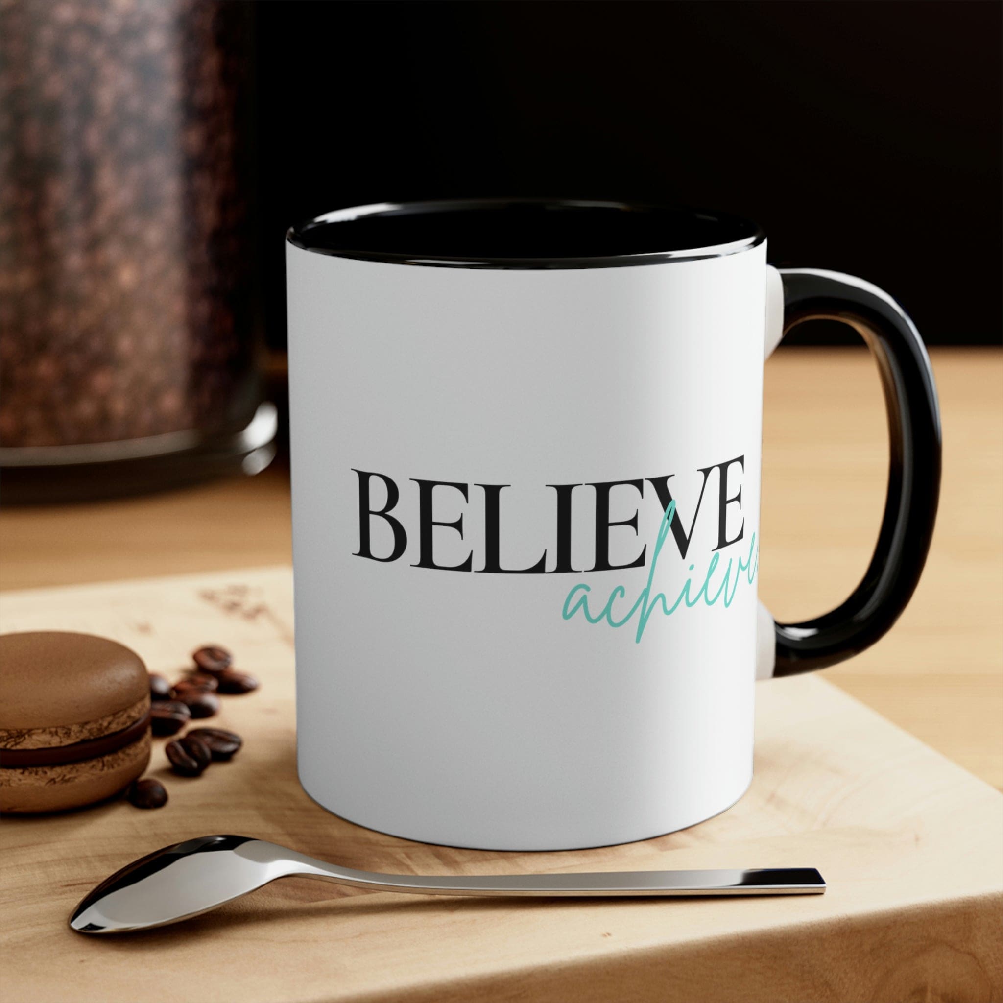 Two-tone ceramic mug with a C-handle, featuring a colorful interior and the inspirational phrase 'Believe and Achieve'.