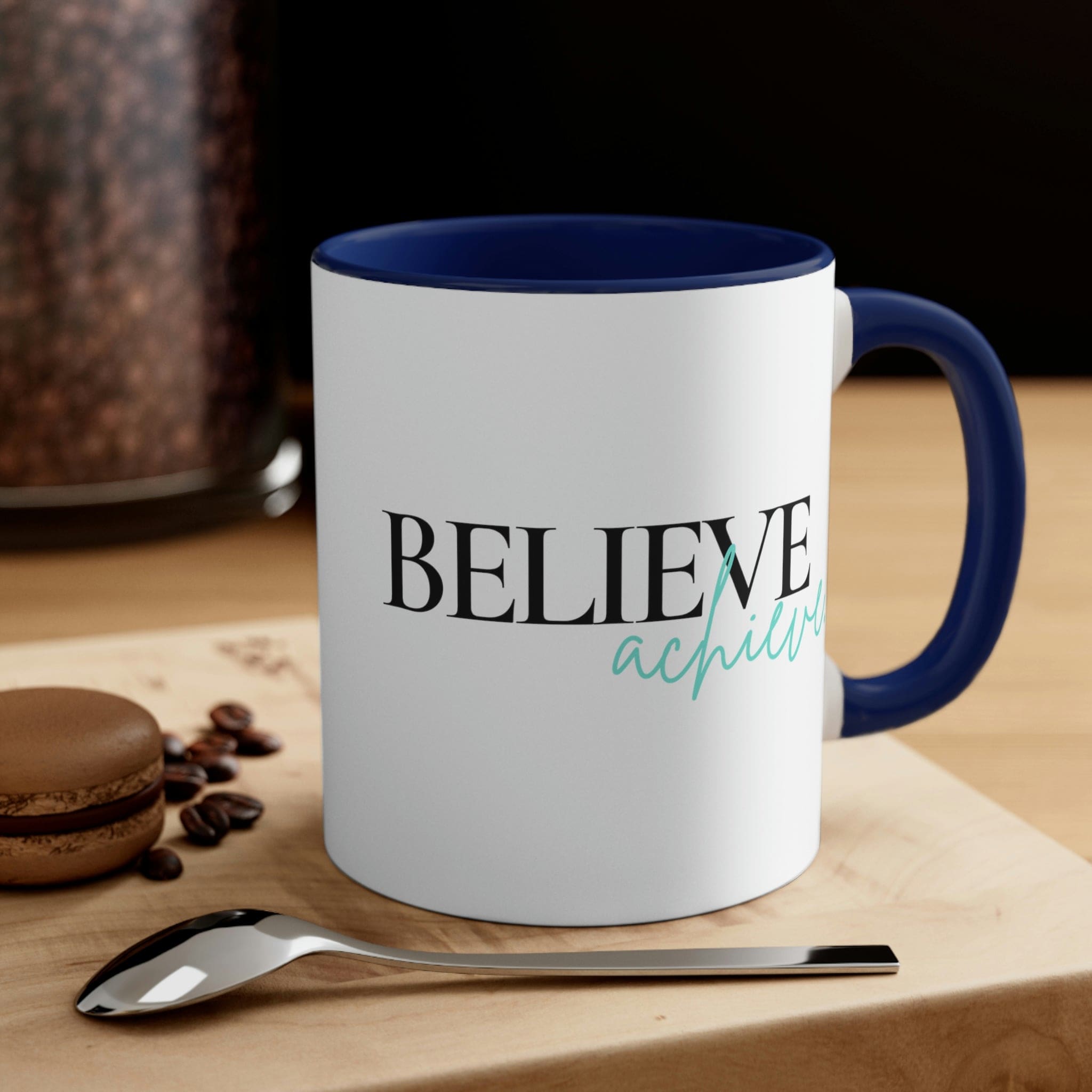 Two-tone ceramic mug with a C-handle, featuring a colorful interior and the inspirational phrase 'Believe and Achieve'.