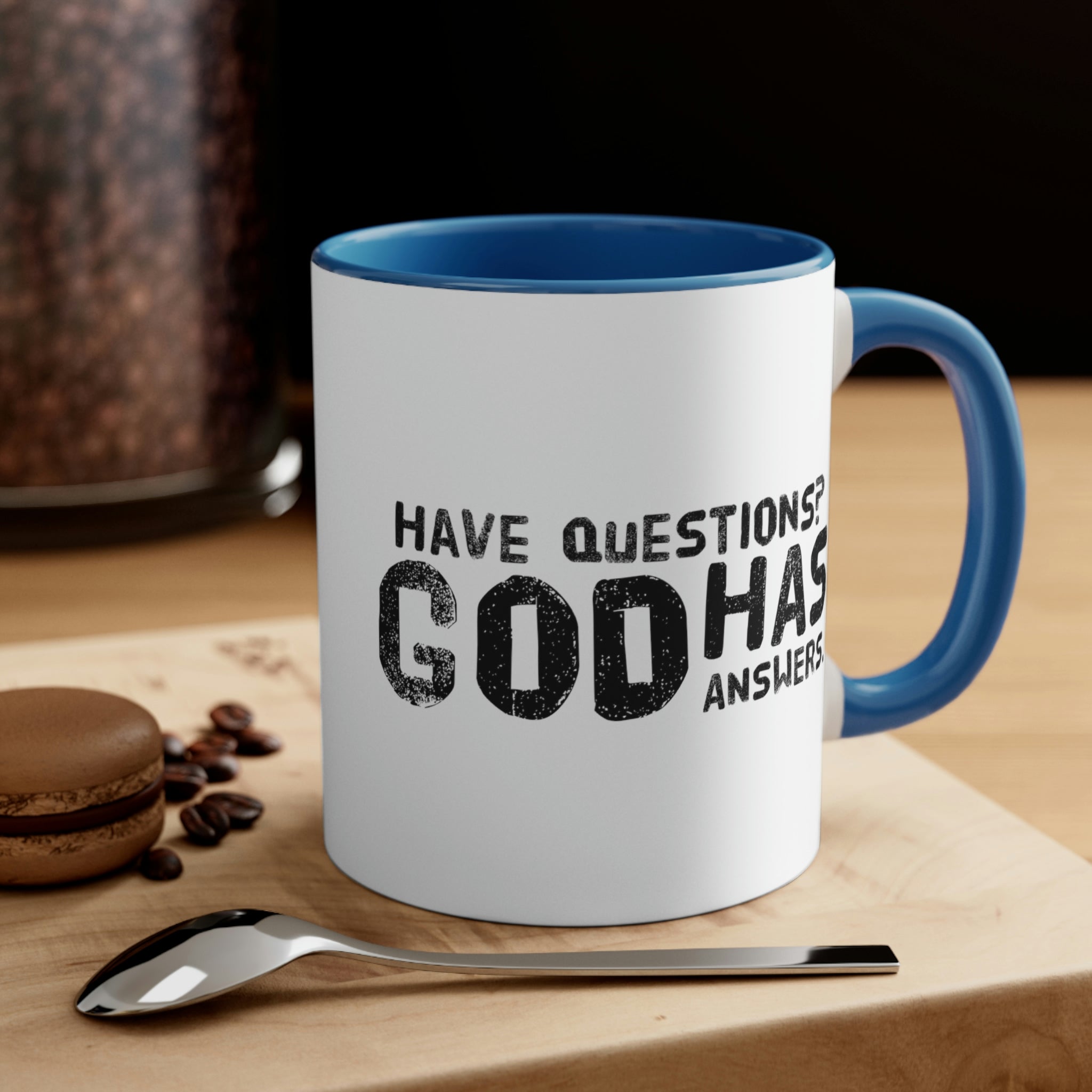 Two-tone ceramic mug with a colorful interior and handle, featuring the print 'Have Questions? God has Answers'.