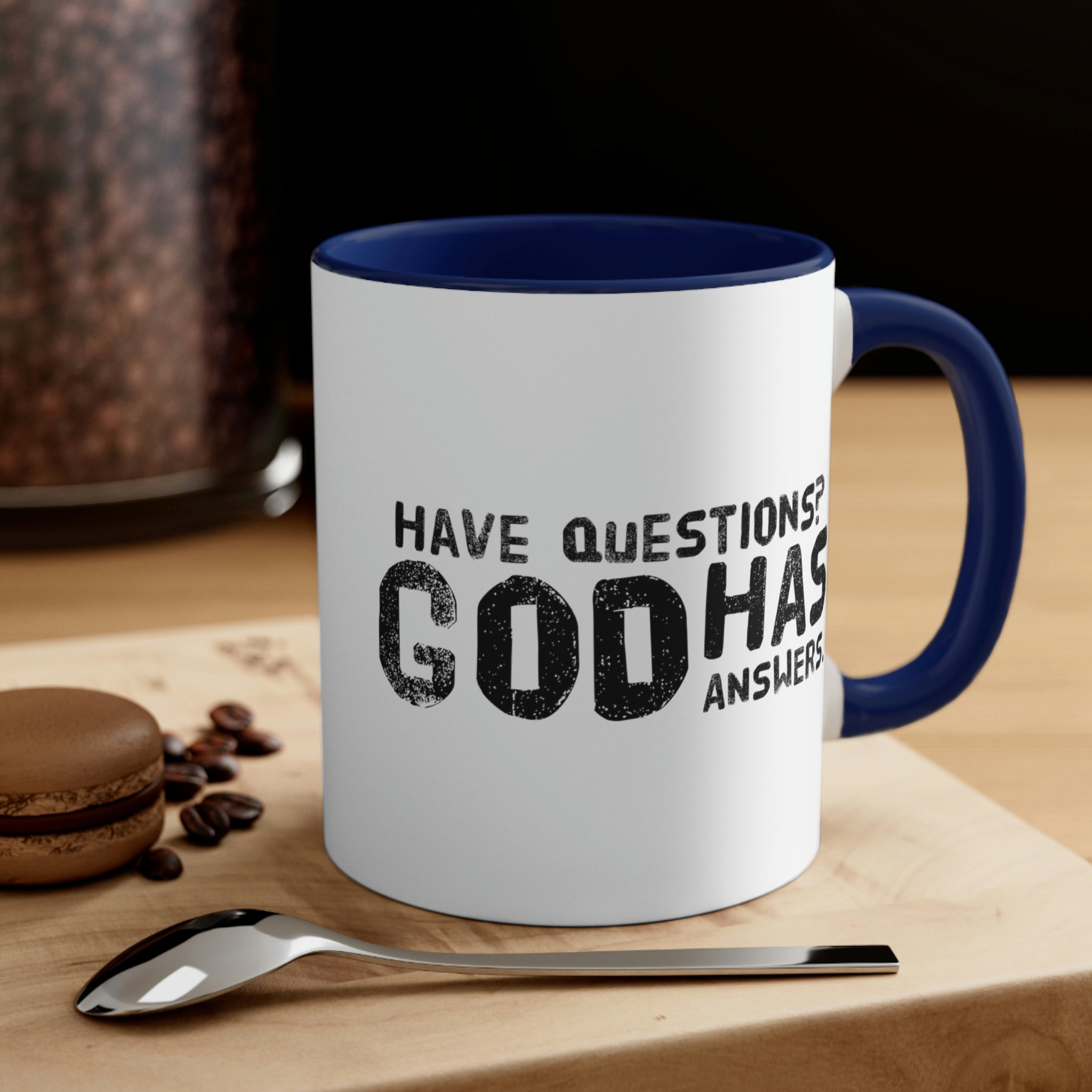 Two-tone ceramic mug with a colorful interior and handle, featuring the print 'Have Questions? God has Answers'.