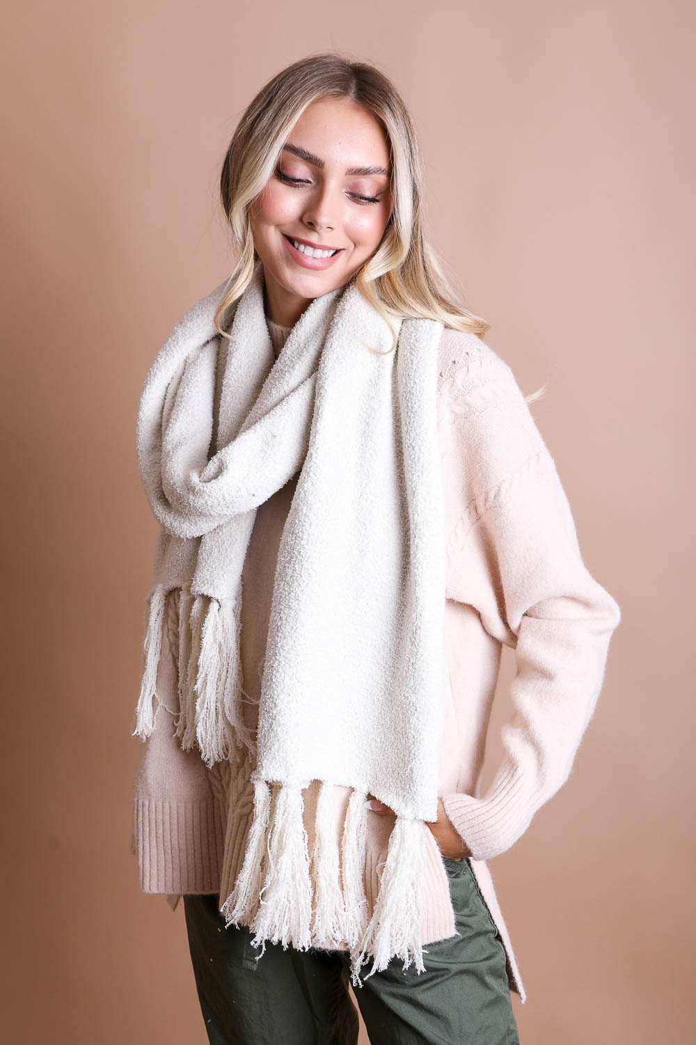 A cozy Ultra-Soft Boucle Tassel Scarf in a stylish design, featuring soft acrylic material and trendy tassels at both ends.