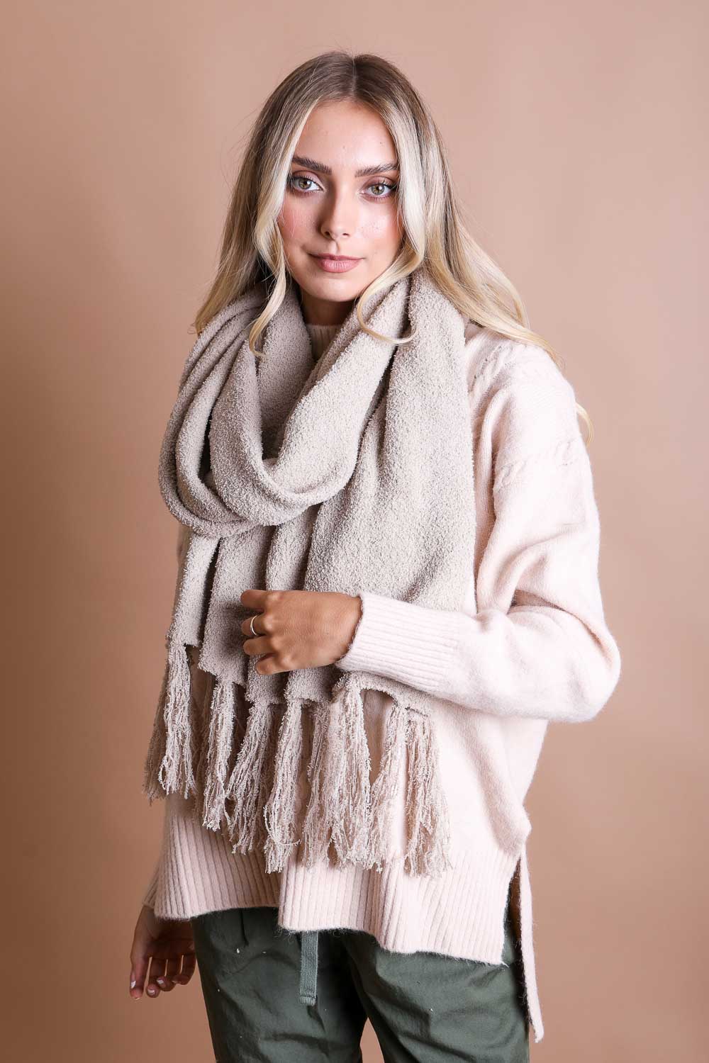 A cozy Ultra-Soft Boucle Tassel Scarf in a stylish design, featuring soft acrylic material and trendy tassels at both ends.