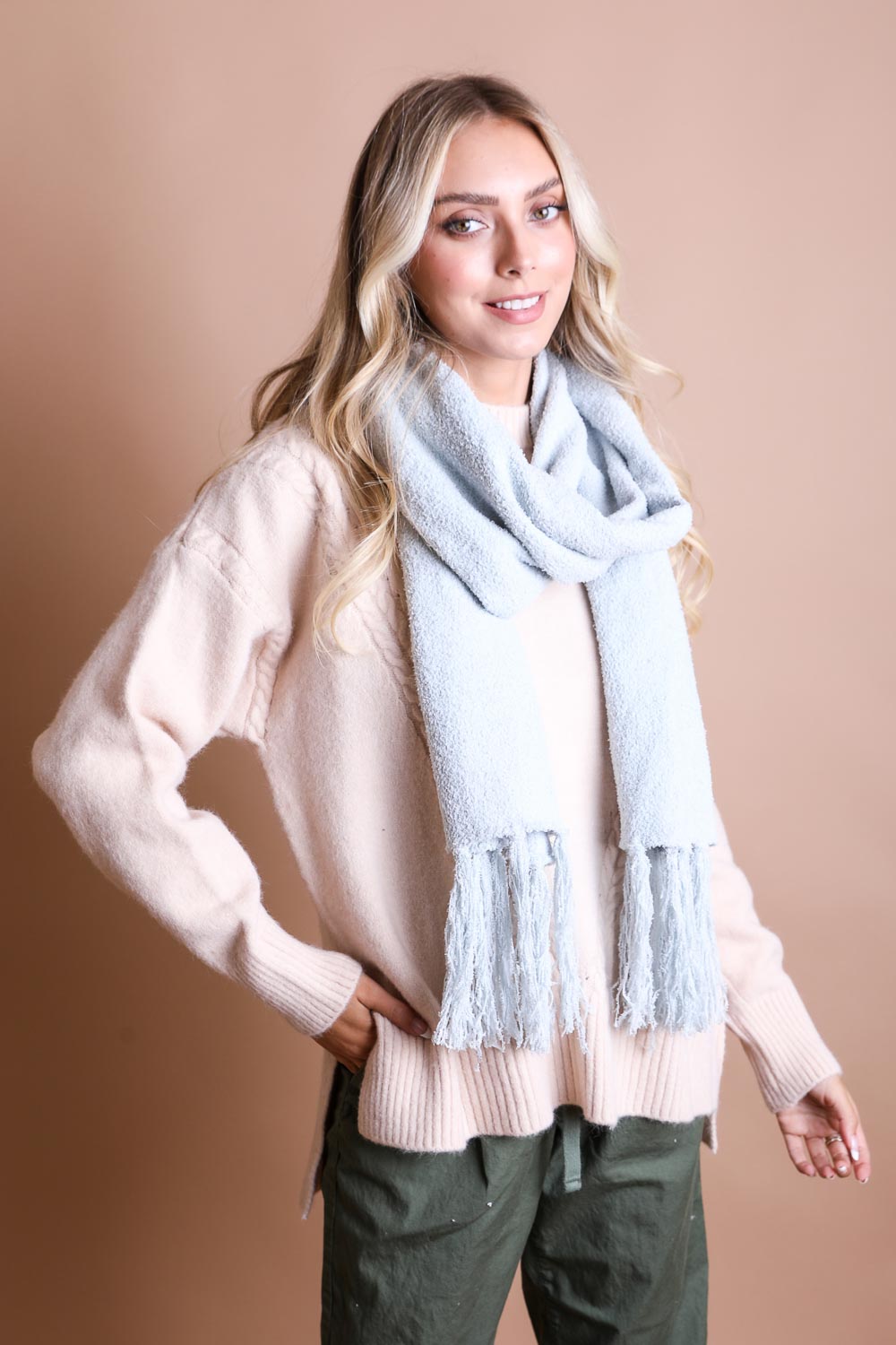 A cozy Ultra-Soft Boucle Tassel Scarf in a stylish design, featuring soft acrylic material and trendy tassels at both ends.