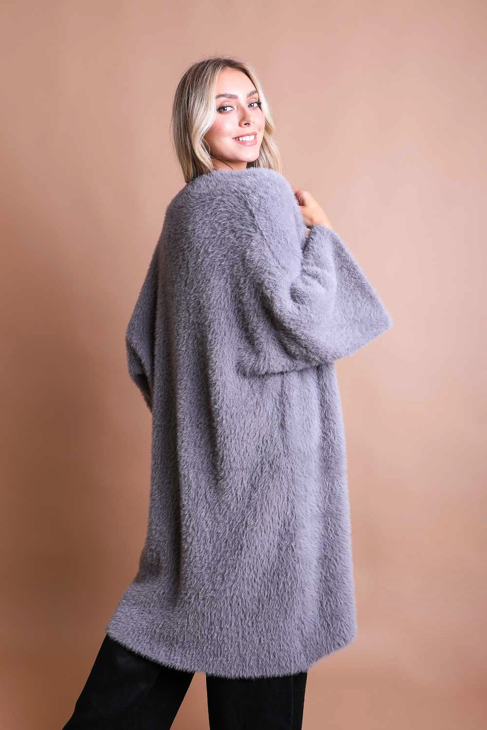 A cozy Ultra-Soft Luxe Mohair Knit Cardigan featuring dolman sleeves and a faux fur collar, perfect for winter wear.