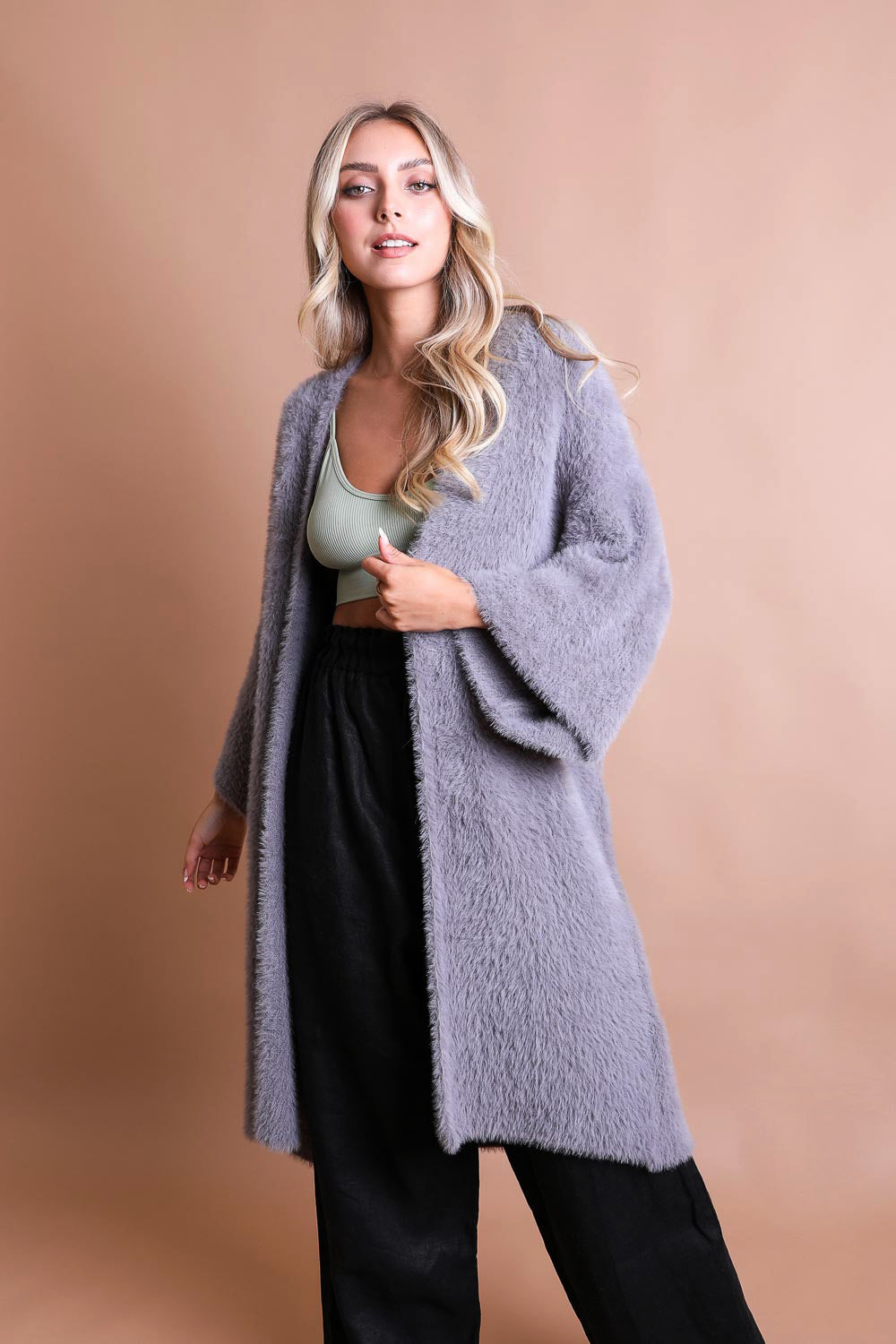 A cozy Ultra-Soft Luxe Mohair Knit Cardigan featuring dolman sleeves and a faux fur collar, perfect for winter wear.