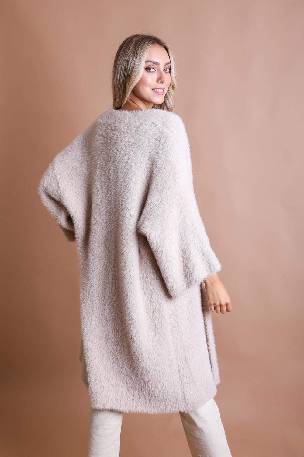 A cozy Ultra-Soft Luxe Mohair Knit Cardigan featuring dolman sleeves and a faux fur collar, perfect for winter wear.