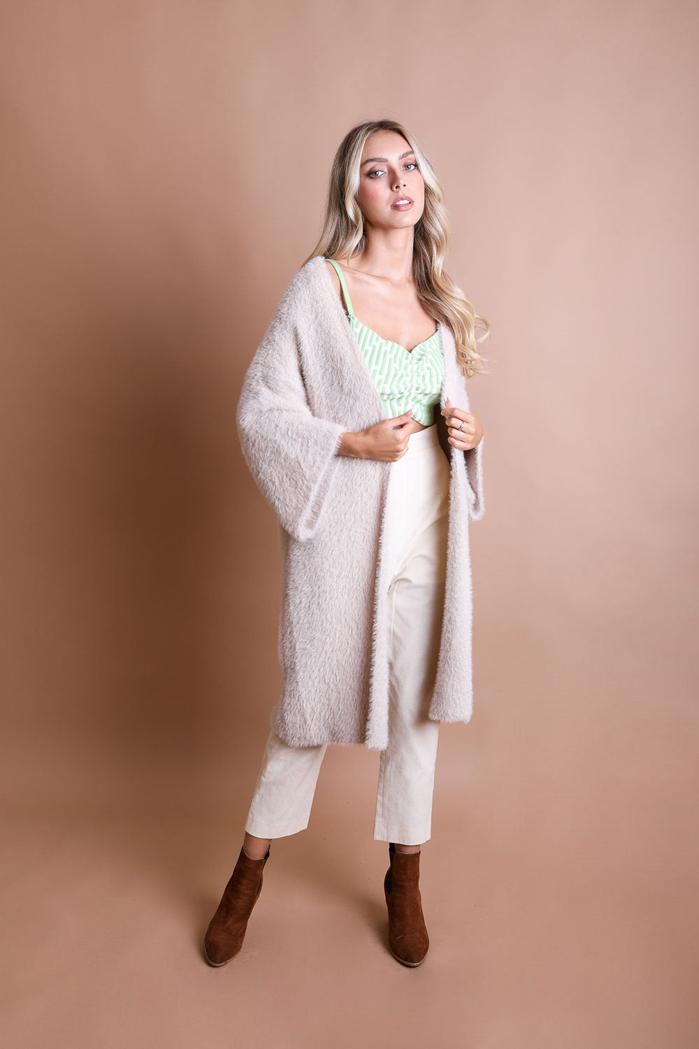 A cozy Ultra-Soft Luxe Mohair Knit Cardigan featuring dolman sleeves and a faux fur collar, perfect for winter wear.