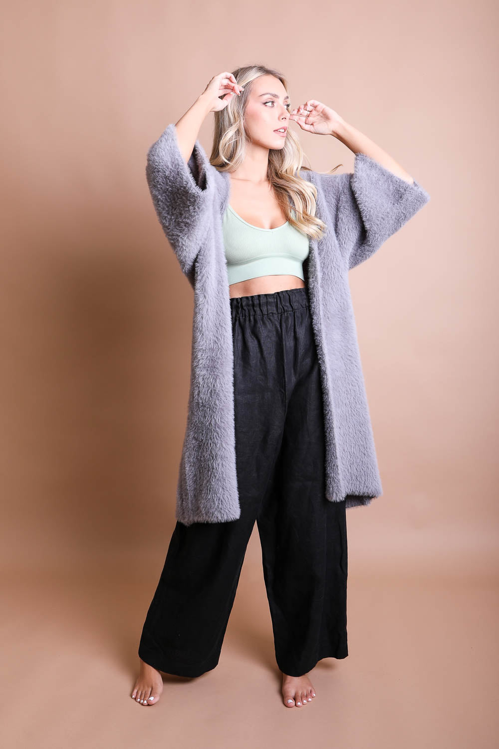 A cozy Ultra-Soft Luxe Mohair Knit Cardigan featuring dolman sleeves and a faux fur collar, perfect for winter wear.