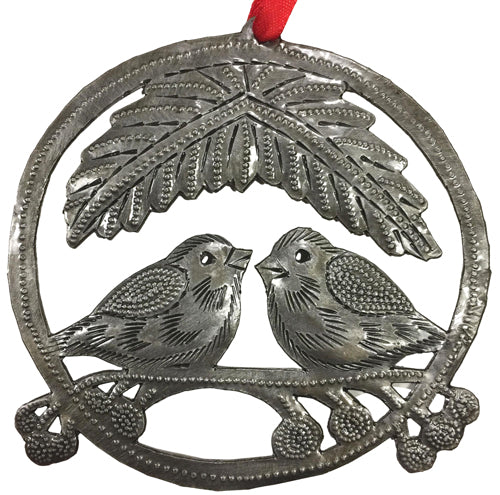 A collection of beautifully handcrafted upcycled metal ornaments from Haiti, showcasing unique designs like angels, elephants, and hearts.