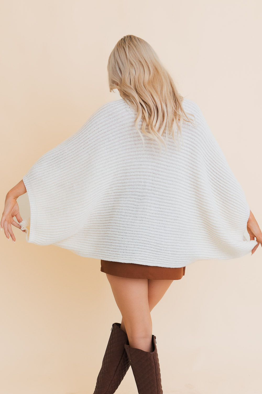 Urban Chic Ribbed Knit Sleeve Poncho featuring stylish ribbed sleeves and a flowing silhouette, perfect for urban fashion.