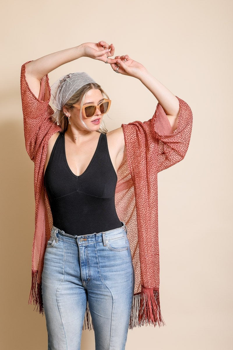 A stylish Velvet Dot Tassel Kimono featuring a textured design and tassel details, perfect for layering over various outfits.