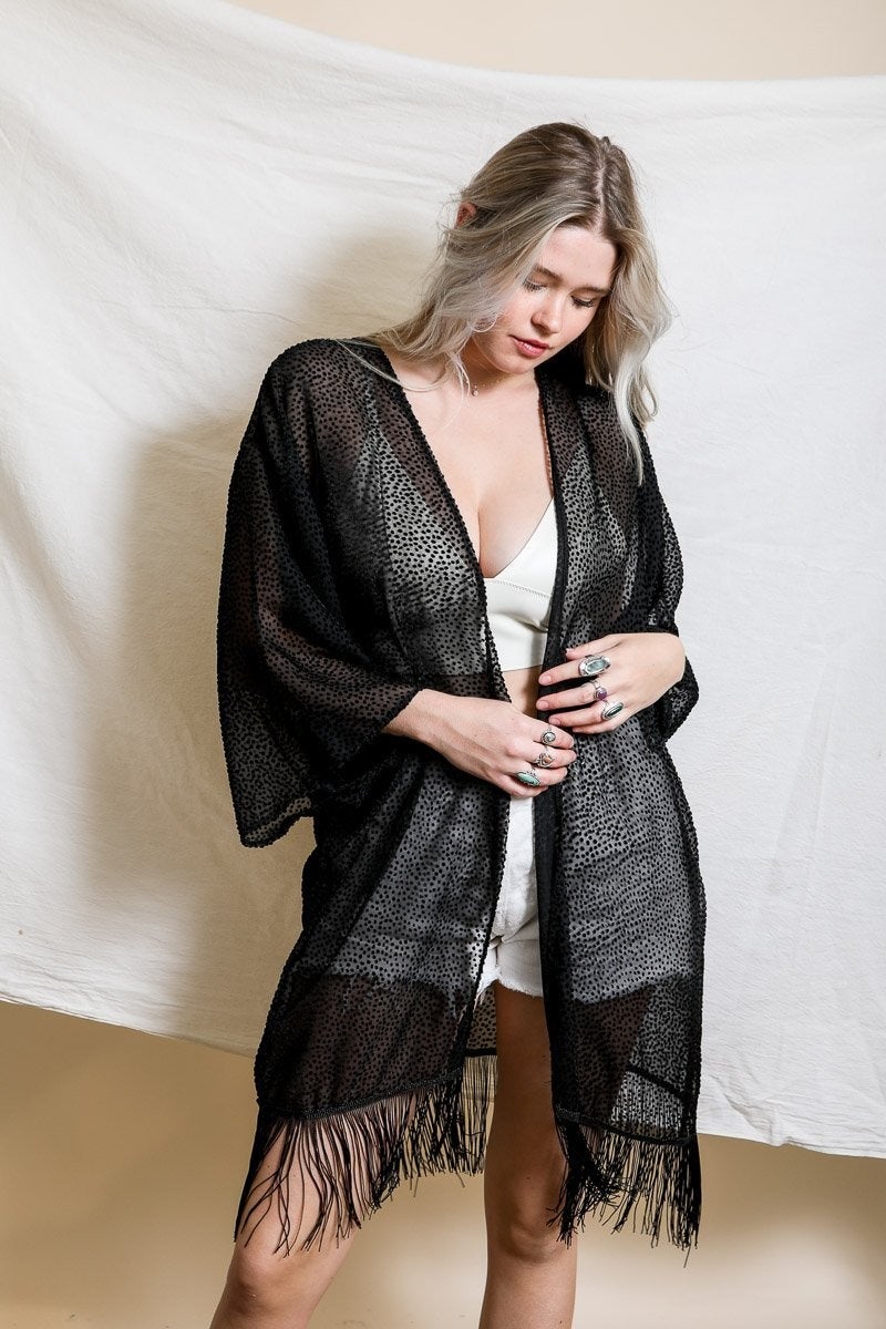 A stylish Velvet Dot Tassel Kimono featuring a textured design and tassel details, perfect for layering over various outfits.