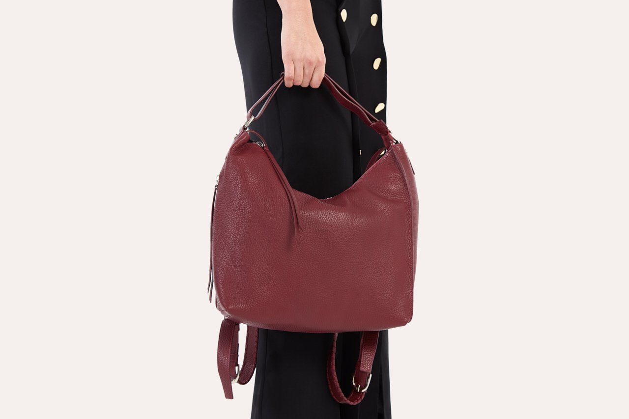 Versatile Shoulder Bag made of genuine pebble leather with adjustable straps and multiple pockets, showcasing its stylish and functional design.