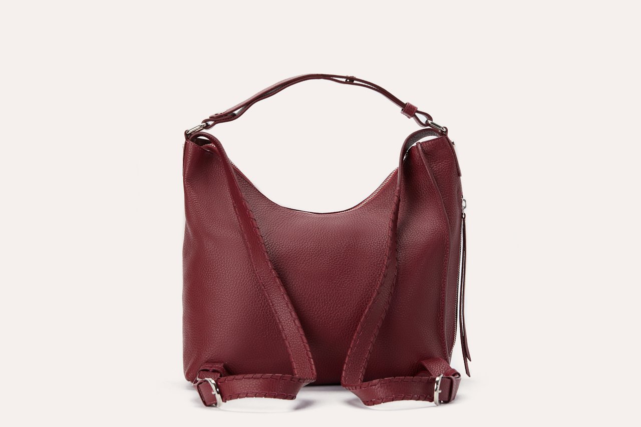 Versatile Shoulder Bag made of genuine pebble leather with adjustable straps and multiple pockets, showcasing its stylish and functional design.