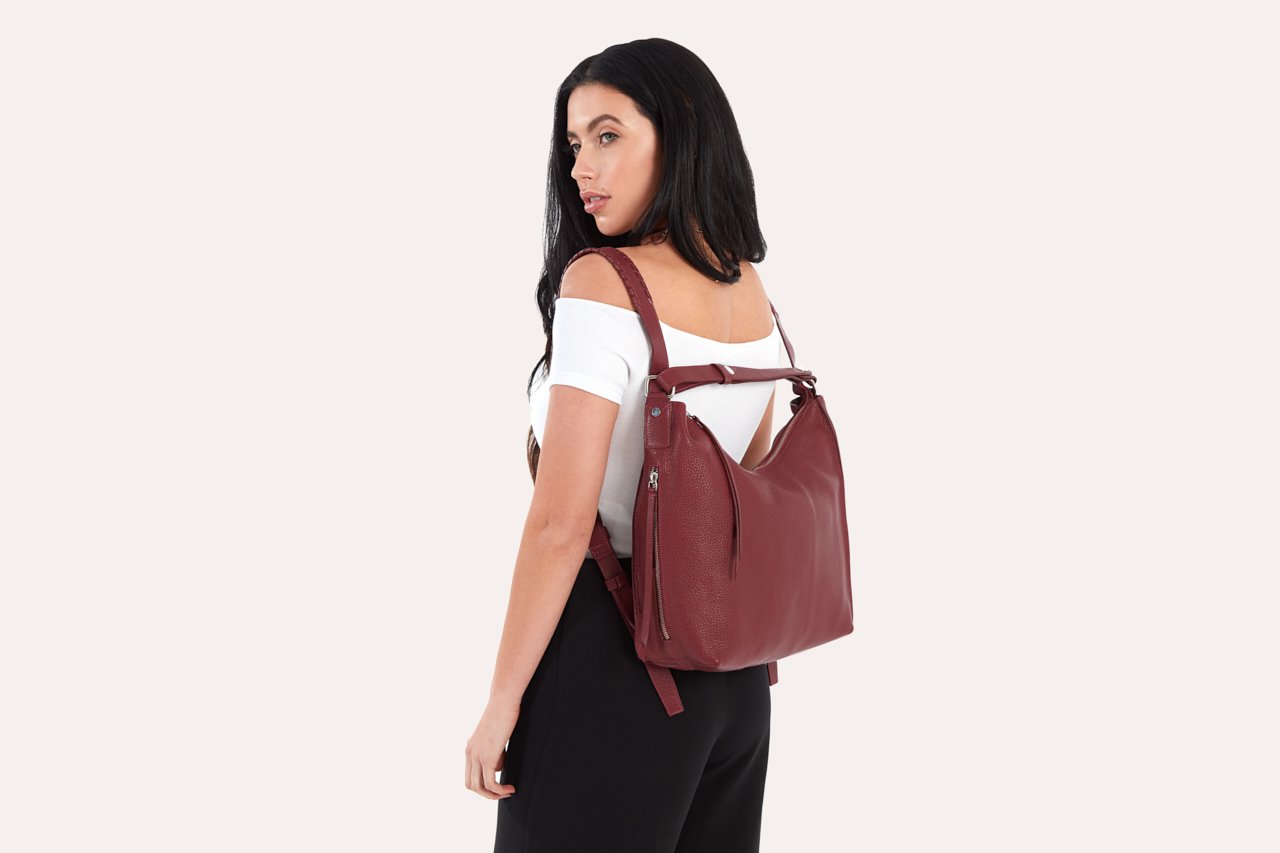 Versatile Shoulder Bag made of genuine pebble leather with adjustable straps and multiple pockets, showcasing its stylish and functional design.