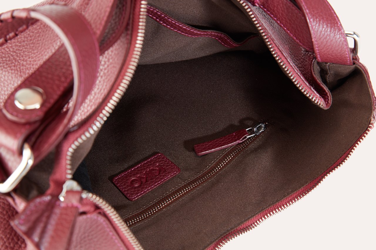 Versatile Shoulder Bag made of genuine pebble leather with adjustable straps and multiple pockets, showcasing its stylish and functional design.