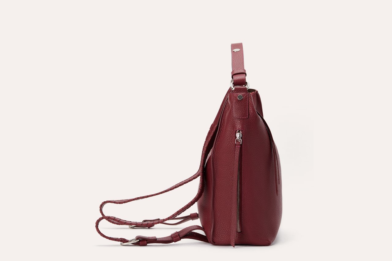 Versatile Shoulder Bag made of genuine pebble leather with adjustable straps and multiple pockets, showcasing its stylish and functional design.