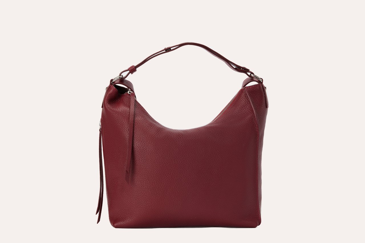 Versatile Shoulder Bag made of genuine pebble leather with adjustable straps and multiple pockets, showcasing its stylish and functional design.