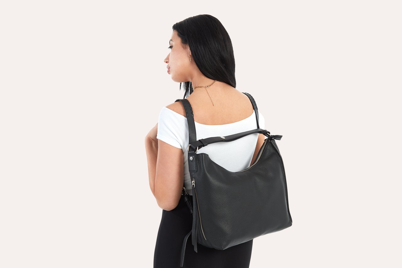 Versatile Shoulder Bag made of genuine pebble leather with adjustable straps and multiple pockets, showcasing its stylish and functional design.