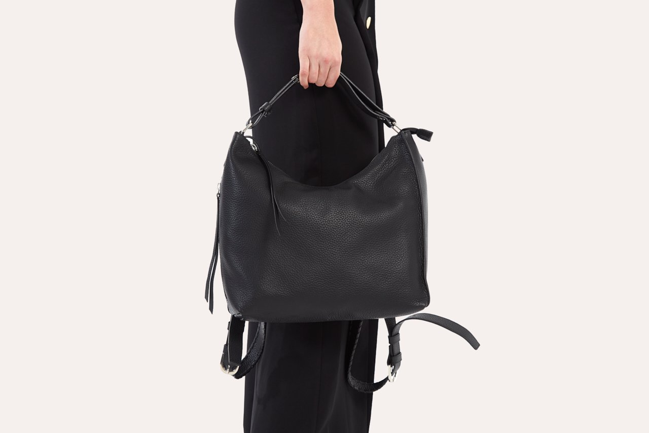 Versatile Shoulder Bag made of genuine pebble leather with adjustable straps and multiple pockets, showcasing its stylish and functional design.