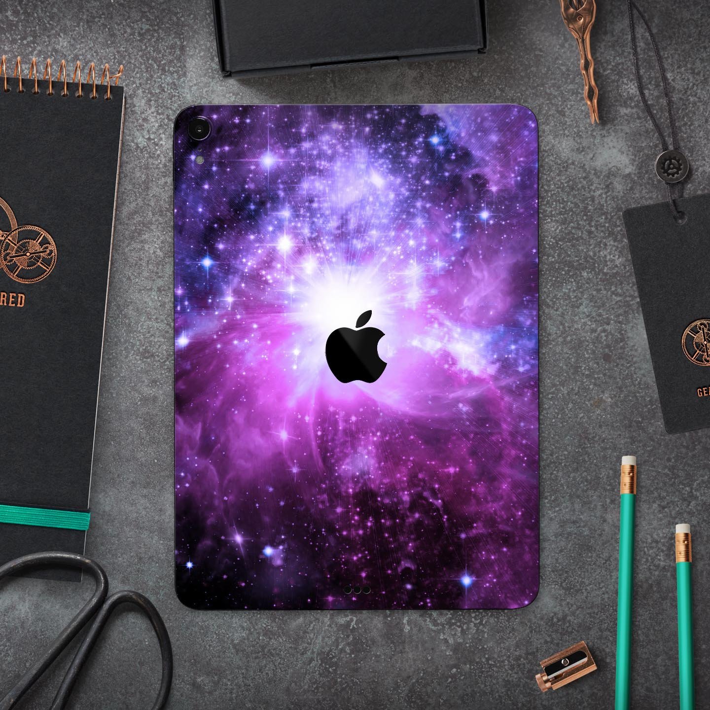 Violet Glowing Nebula skin decal for Apple iPad Pro, showcasing vibrant colors and a cosmic design.