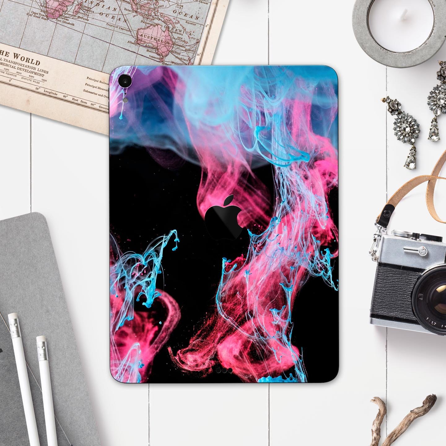 Vivid Pink and Teal liquid Cloud skin decal for Apple devices, showcasing vibrant colors and a sleek design.