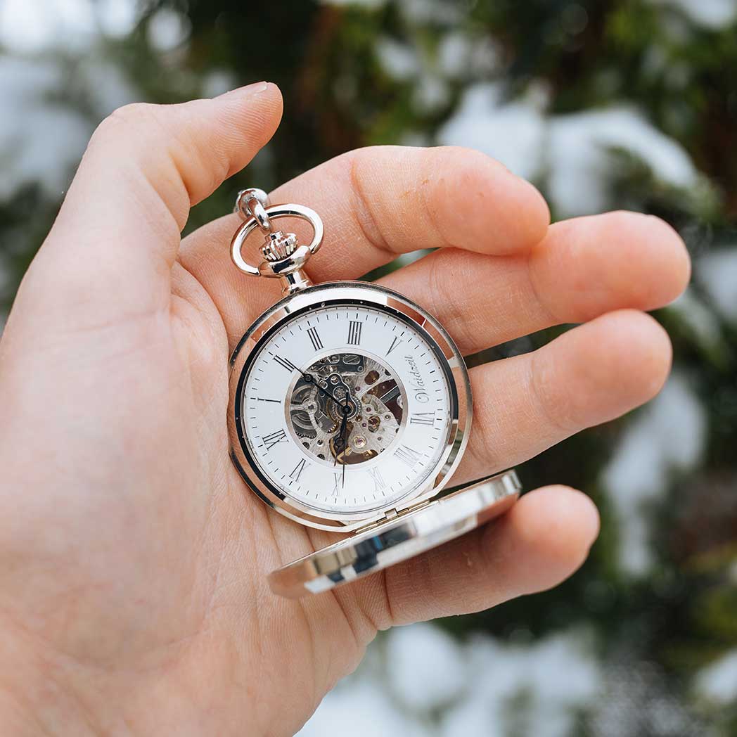 Waidzeit Franz Joseph Skeleton pocket watch in silver with Roman numerals and root wood accents, showcasing intricate mechanical movement.