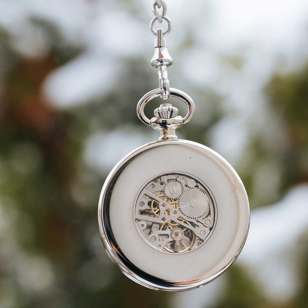 Waidzeit Franz Joseph Skeleton pocket watch in silver with Roman numerals and root wood accents, showcasing intricate mechanical movement.