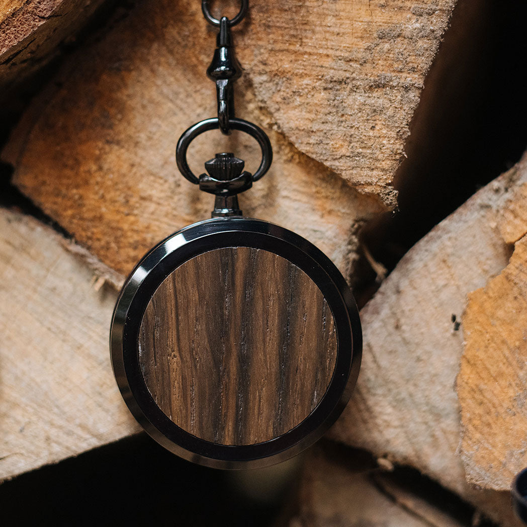 Waidzeit Franz Theodor Skeleton pocket watch featuring a black-plated stainless steel case, white Roman numerals, and a bog oak spring cover.