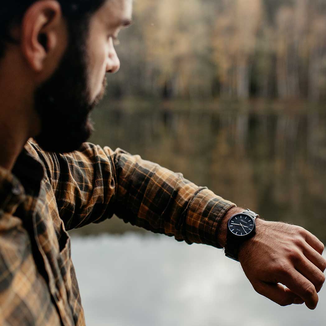 Waidzeit Mystic Solar watch featuring a bog oak case and wooden strap, showcasing solar technology and elegant design.