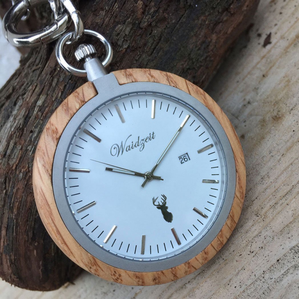 Waidzeit Olive Pocket Watch featuring a snow-white dial, olive wood casing, and stainless steel elements, elegantly displayed in a wooden box.