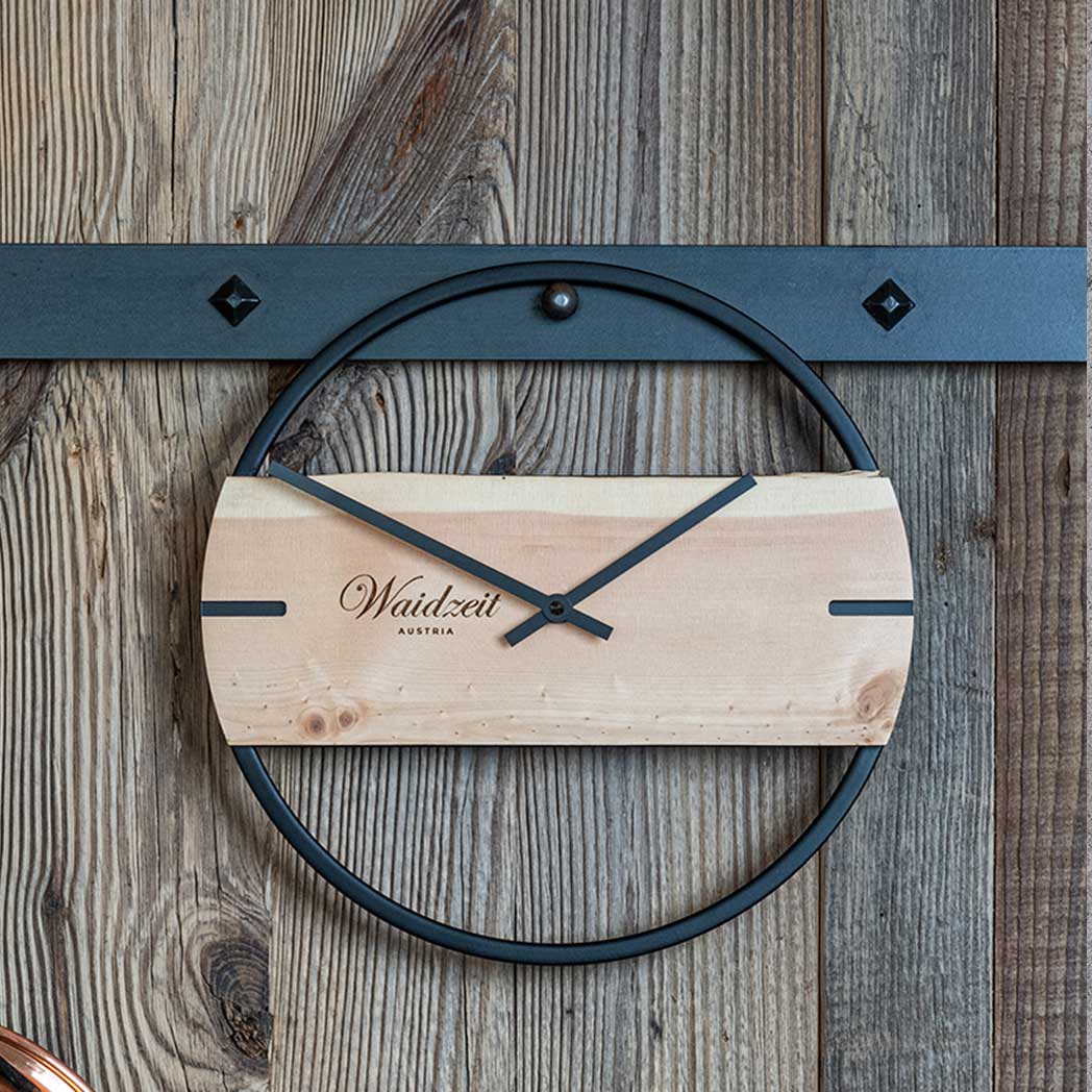 Waidzeit Novum wall clock made from arolla pine wood with a black metal ring, showcasing minimalist Scandinavian design.