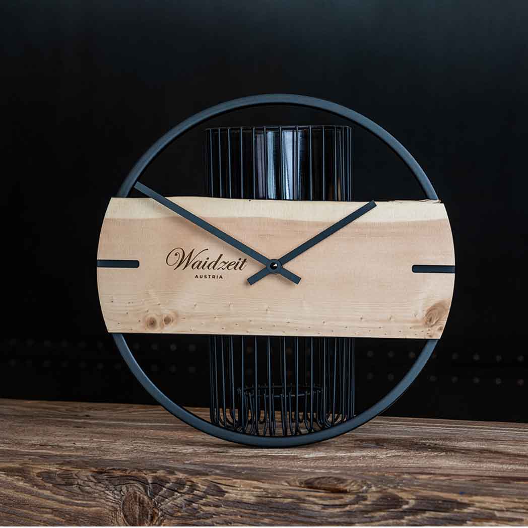 Waidzeit Novum wall clock made from arolla pine wood with a black metal ring, showcasing minimalist Scandinavian design.