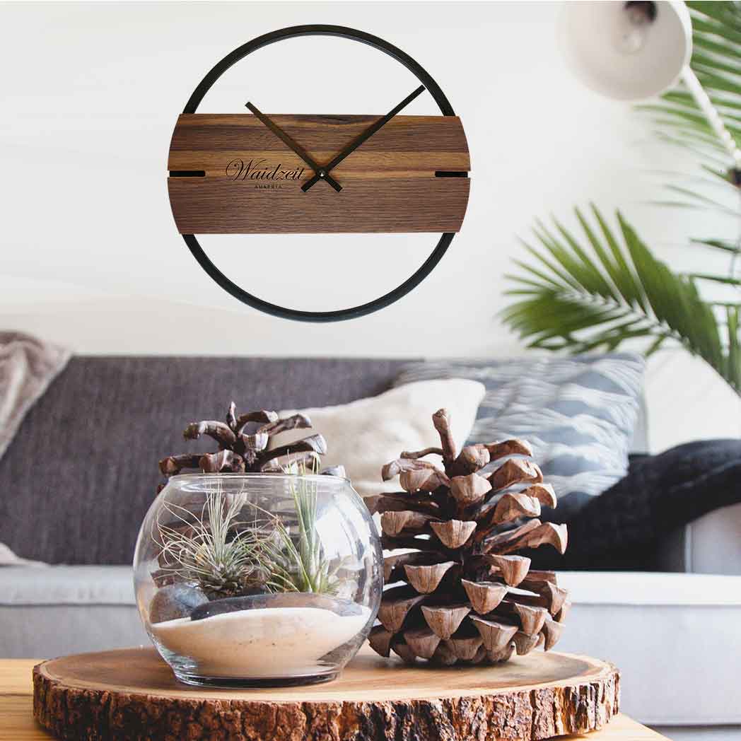 Waidzeit Novum wall clock in walnut with black metal ring, showcasing elegant Scandinavian design and natural wood grain.